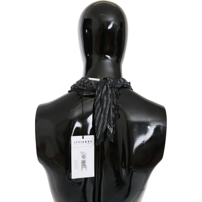 Back view of a mannequin wearing a black gray viscose branded scarf by CoSTUME NATIONAL.